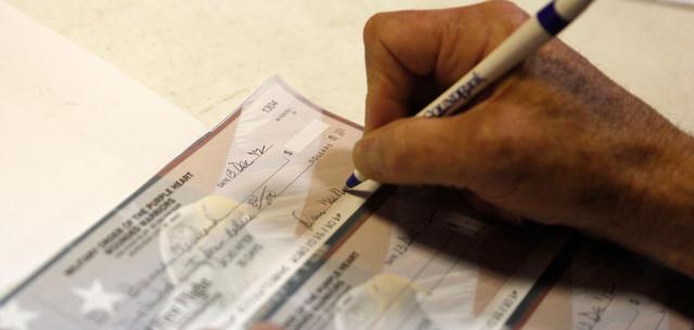 Service member writing a check