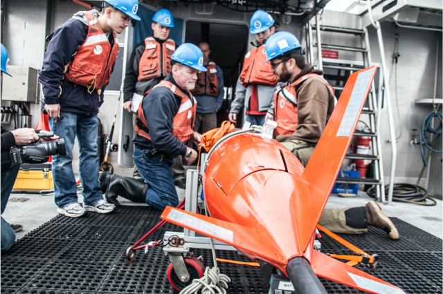 Faculty and students from NPS’ Physics Department recover autonomous gliders for environmental monitoring. 