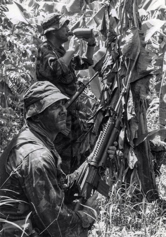 Members of a SEAL platoon pause in the jungle