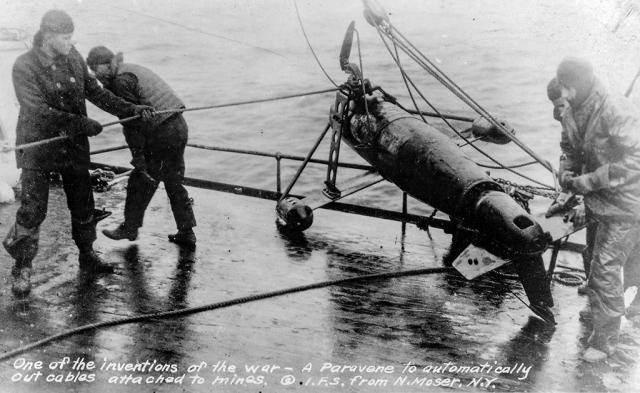 Postcard showing a minesweeping paravane on the deck of a ship during World War I.