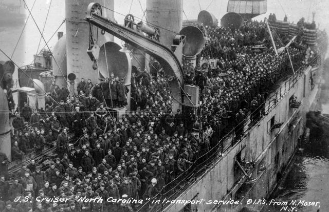 Overhead view of the decks of the armored cruiser USS North Carolina crowded with soliders.