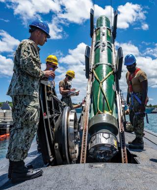 In this scenario, lengthy transits to reload torpedoes have limited U.S. submarines to about 25 percent on-station time. Here, sailors assigned to the USS Columbia  (SSN-771) load a Mk 48 AdCap torpedo. 