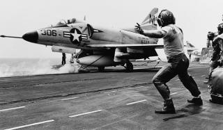 The catapult officer signals launch and an A-4 Skyhawk starts down the flight deck during operations in the South China Sea in March 1965. The wars in Korea and Vietnam highlighted the utility of a navy capable of operating in international waters and projecting power ashore.