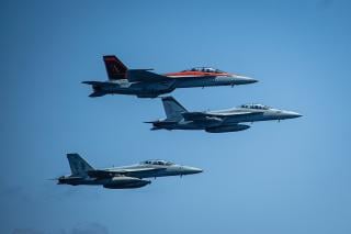 F/A-18F Super Hornets assigned to the aircraft carrier USS Nimitz (CVN-68) fly in formation over the Philippine Sea
