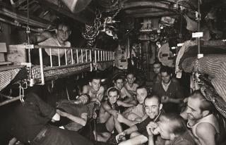 A large group of men inside of a U-boat.