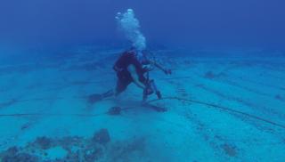 sailor tracks an underwater cable