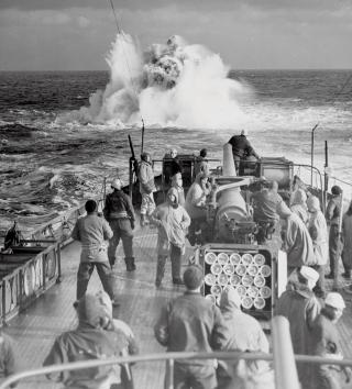A Coast Guard combat cutter patrolling the North Atlantic looses a depth charge in battle practice sometime during World War II.