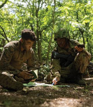 A U.S. Marine  and a JGSDF member plan their next defensive position during exercise Resolute Dragon 24. Partner forces can provide knowledge of local terrain and access to remote locations.