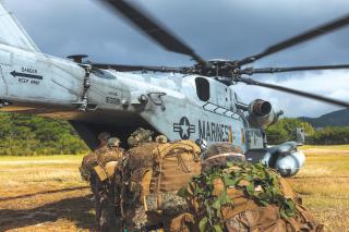 Marines with 1st Battalion, 2d Marines, board a CH-53E Super Stallion for an air insertion during Stand-in Force Exercise on Okinawa, Japan, in December 2022. A Concept for Stand-in Forces lays out a new vision for the employment of Marines in support of naval campaigns and joint operations.