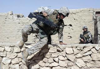 Marines hurtling over walls during a mission in Karbala, Iraq, during Operation Spear.
