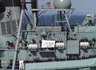 After the 11 September attacks, sailors on the German destroyer Lutjens man the rails and hold a hand-made banner reading: “We Stand By You.” Both a U.S. and German flag were flying at half-mast from the yardarms. 