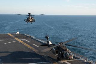 A U.S. Army AH-64 Apache helicopter lands on board the amphibious assault carrier USS Tripoli (LHA-7) operating in the Pacific Ocean. The Army has already experimented with all-domain operations centers, and these will likely be a focal point for joint all-domain operations.