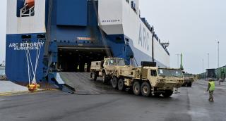 Soldiers from the U.S. Army 10th Mountain Division guide vehicles onto the ARC Integrity at the Finnish port of Kemi for the NATO Defender 24 exercise. The joint force will depend on commercial ships to help transport matériel to combat zones. But alternative-fuel-powered vessels sometimes sail at slower speeds and with shorter range, complexifying the Navy’s ability to operate alongside them.