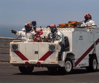 Members of the Theodore Roosevelt’s crash and salvage team. These aviation boatswain’s mate (handling) sailors are the first on scene to an aircraft crash or fire.
