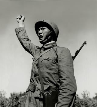 A soldier of the 102nd Field Artillery Battalion, 2nd Division, IX Chinese Nationalist Corps, gives the order to fire during training on 7 December 1954.