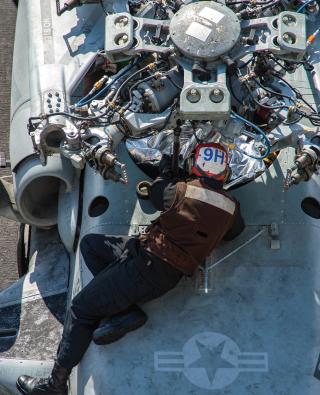 A maintainer with Helicopter Sea Combat Squadron 11, works on an MH-60S Seahawk helicopter on board the USS Harry S. Truman (CVN-75). Adequate time off is needed to ensure all sailors are at peak performance for the safety of all involved.