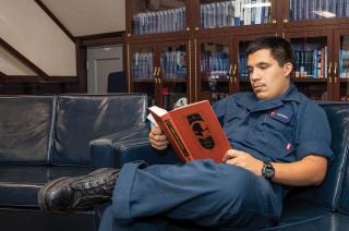 A sailor in the library on board the USS George H.W. Bush (CVN-77)
