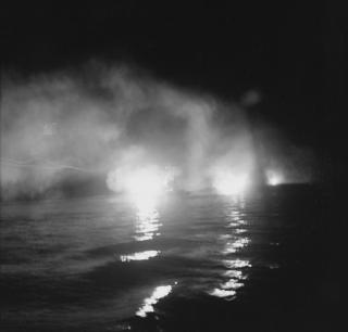With the USS St. Louis astern, the Helena (center) fires during the night battle. The size of the flashes suggests that the U.S. cruisers had already run through their supply of flashless powder for their 6-inch guns, placing this photo after the first two minutes of the action. Meanwhile, Japanese Type 93 torpedoes are already on their deadly way.