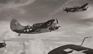 U.S. Navy SB2C-1C Helldivers of Task Force 58 are airborne on a mission near Saipan as the great armada moves in for the invasion of the Japanese bastion. 