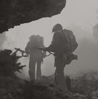 “Into the Valley of Death”: Marines creep through the mist and smoke during the hard-fought Battle of Saipan. Japanese General Yoshitsugu Saito’s final order declared, “I will leave my bones on Saipan as a bulwark of the Pacific.”