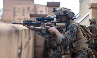 A U.S. Marine with the Maritime Special Purpose Force, 26th Marine Expeditionary Unit, provides security in an urban environment training course on Marine Corps Base Camp Lejeune, North Carolina, in November 2022. While there are higher costs for urban operations, both movement and offensive maneuver are still possible in steel and masonry canyons.