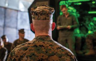 Collaborative command would  maximize and combine the creative contributions of all subordinate commanders and their staffs throughout operations. Here, the commanding general, 3d Marine Division, receives a briefing on board the USS Harpers Ferry (LSD-49).