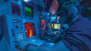 perations specialist monitors surface contacts from the combat information center on board the USS John S. McCain (DDG-56) 