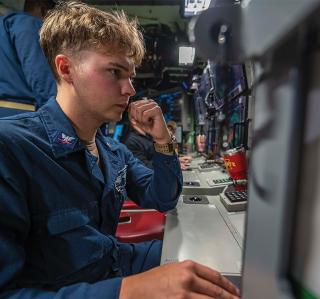 A fire-control technician stands watch on board the Virginia-class fast-attack submarine USS Mississippi (SSN-782) off the coast of Hawaii. Naval intelligence officers detailed to support undersea warfare commands must receive training in U.S. submarine tactics and operations to best support undersea warfighters.