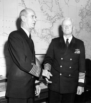Fleet Admirals Ernest J. King and Chester W. Nimitz shaking hands after it was announced Nimitz would succeed King as Chief of Naval Operations. King and Nimitz had different command philosophies but both were able to accomplish their goals.