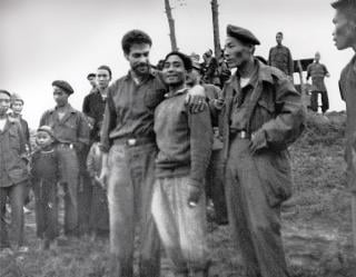 After a hair’s-breadth escape from captivity and grueling trek through the jungle, Klusmann and his fellow escapee Boun Mi express their joy at reaching friendly lines near Boum Long, Laos, on 31 August 1964.