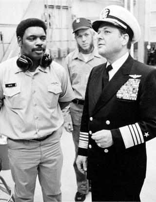 Admiral James L. Holloway III receives a briefing concerning the Diesel Laboratory at the Fleet Ballistic Missile Submarine Training Center, Charleston, South Carolina, 18 March 1976. As CNO, Holloway continued a number of Zumwalt’s efforts to improve the lot of minorities and other sailors and even launched his own Navy affirmative action plan. 