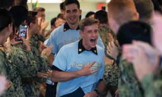 Midshipmen from the U.S. Naval Academy Class of 2023 on service-selection night after learning they were selected for naval aviation. Making a small portion of the service-selection process more random could offset the influence of hidden biases and other subjective factors.