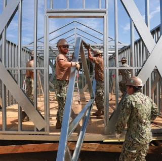 Sailors assigned to Naval Mobile Construction Battalion 4 assemble a building at Naval Base Ventura County, California. To ensure it has the infrastructure to support missions across the Indo-Pacific, the Navy should build back the Seabee force.