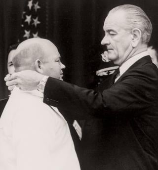 Williams is awarded the Medal of Honor by President Lyndon B. Johnson at the White House on 14 May 1968. When he retired in April 1967, he was the most decorated enlisted sailor in U.S. Navy history.