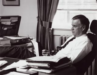 U.S. Naval Institute CEO and publisher, retired Navy Captain Jim Barber, U.S. Naval Institute CEO and publisher, sitting at his desk. Barber guided the Institute through rough seas, from which it emerged stronger than ever.