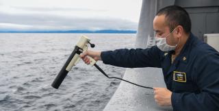 A chief mineman fires the expendable bathythermograph into the water