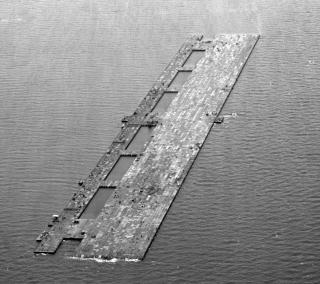 Habbakuk originated in September 1942 in British Combined Operations under the command of Admiral Louis Lord Mountbatten as an ambitious plan to construct immense aircraft carriers out of an ice–wood pulp mixture called pykrete. The vessels would carry large, land-based heavy bombers to help close the Mid-Atlantic gap and protect supply convoys bound for England. Quickly and cheaply built out of nonstrategic materials, the ships would withstand mines, torpedoes, and bombs and be unsinkable. 