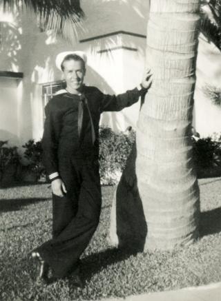Photo of Sailor, WWII, Standing by palm tree