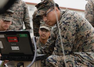 Marines with 3d Intelligence Battalion, III Marine Expeditionary Force Information Group, work with a palletized intelligence terminal.