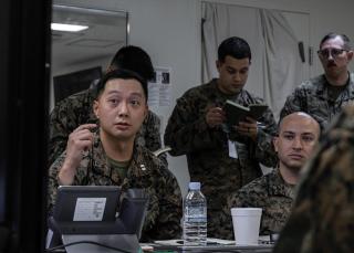 Marines with 3d Intelligence Battalion, III Marine Expeditionary Force Information Group, work with a palletized intelligence terminal (top) and participate in a brief (bottom) during the Talent Aries 25.1 exercise on Camp Kinser, Okinawa, Japan, in December 2024.