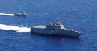The Independence-variant littoral combat ship USS Gabrielle Giffords (LCS-10) steams alongside the unmanned surface vessel Ranger as they transit the Pacific Ocean during Integrated Battle Problem 23.2 in September 2023. Littoral combat ships and uncrewed air, surface, and subsurface vessels—increasingly augmented with artificial intelligence—could help the Navy establish sea denial in the western Pacific before 2035.