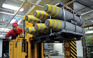 Aircraft carriers are power projection platforms with high-capacity magazines. Here, an aviation ordnanceman moves Mk 80-series bombs within a magazine on board the USS George H. W. Bush (CVN-77). 