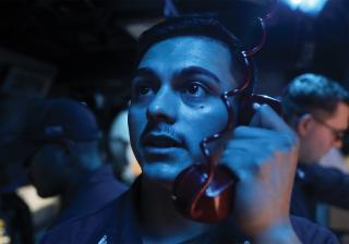 petty officer relays target coordinates on board the destroyer USS Barry