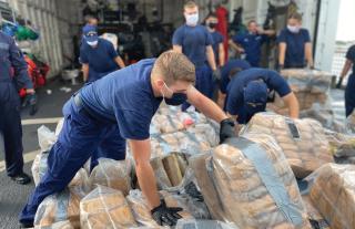 crew of the USCGC Escanaba (WMEC-907) offload seizing narcotics