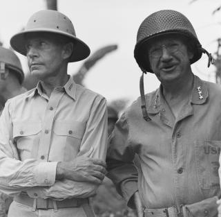 Admiral Raymond A. Spruance, Commander, Fifth Fleet (left), and Marine Lieutenant General Holland M. "Howlin' Mad" Smith, Commander, V Amphibious Corps, attend flag raising ceremonies at Smith's Saipan headquarters, marking the end of organized Japanese resistance on the island.