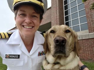 Commander Tracy Krauss and facilities dog Patty Mac. Patty Mac is able to identify people in emotional distress. “Patty breaks the ice and puts them at ease,” Krauss says. She “opens the door and gets people talking.”