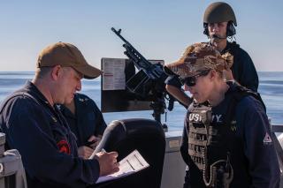 An aviation ordnanceman provides instruction on safe handgun operation during weapons familiarization training. Inclusive language invites service members from all backgrounds into the conversation and can foster an environment in which stereotypes fade and eventually disappear. 