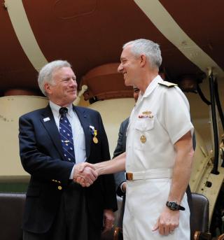 Rear Admiral David Titley, Oceanographer of the Navy, presents Walsh with the Distinguished Public Service Award during a 2010 ceremony at the National Museum of the U.S. Navy.
