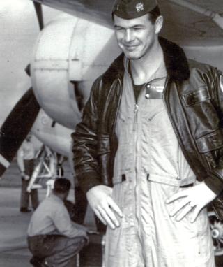 Forrest “Zeke” Zetterberg standing in front of an E-1B tracer