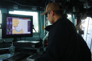 An officer stands watch as navigation evaluator during a sea-and-anchor transit. Allowing a commanding officer to accept some risk—perhaps a second fully qualified navigator in lieu of a navigation evaluator—would reduce emergent manpower burdens on operational units and the vessels providing augments.